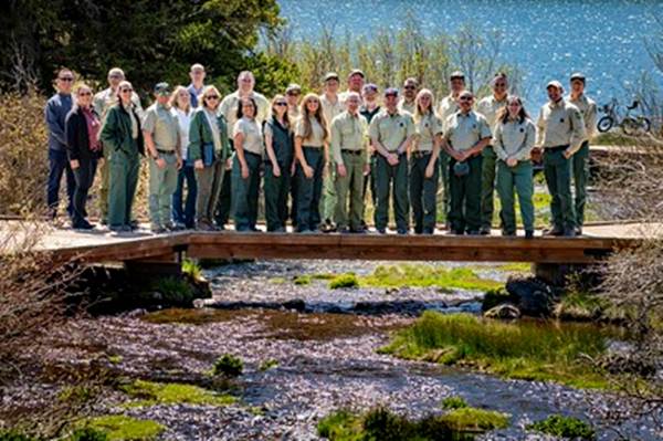 A group of people standing on a bridge over a river
AI-generated content may be incorrect.